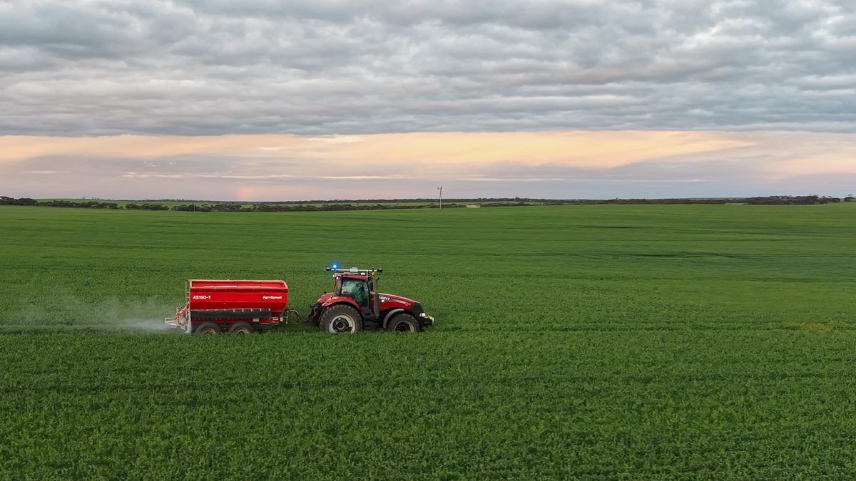 Case IH tractor fitted with an Ornata kit, spreading on a green crop