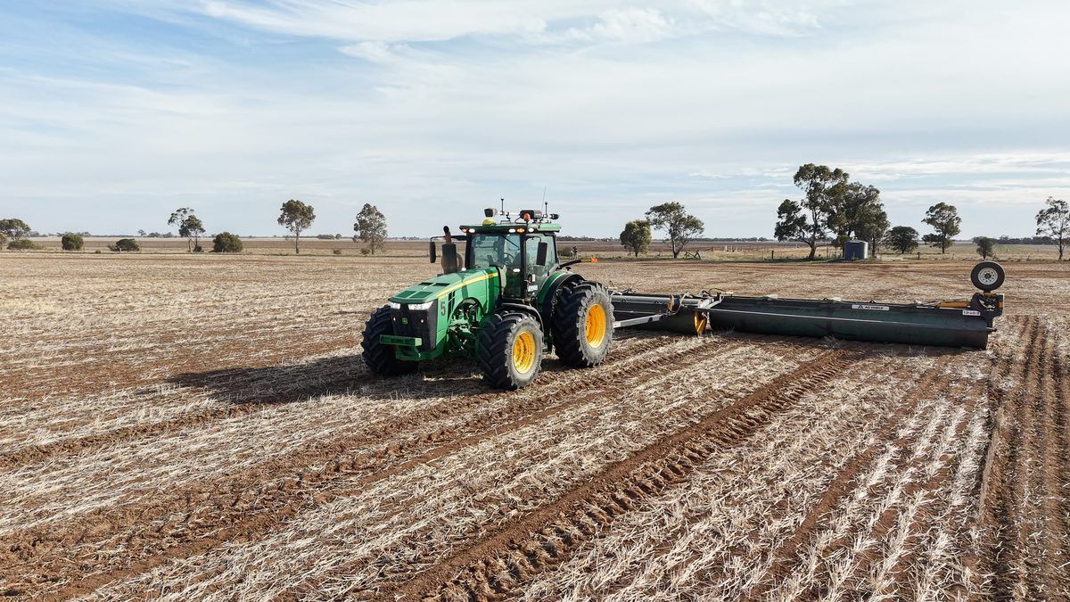 John Deere tractor fitted with an Ornata kit, rolling a stubble paddock